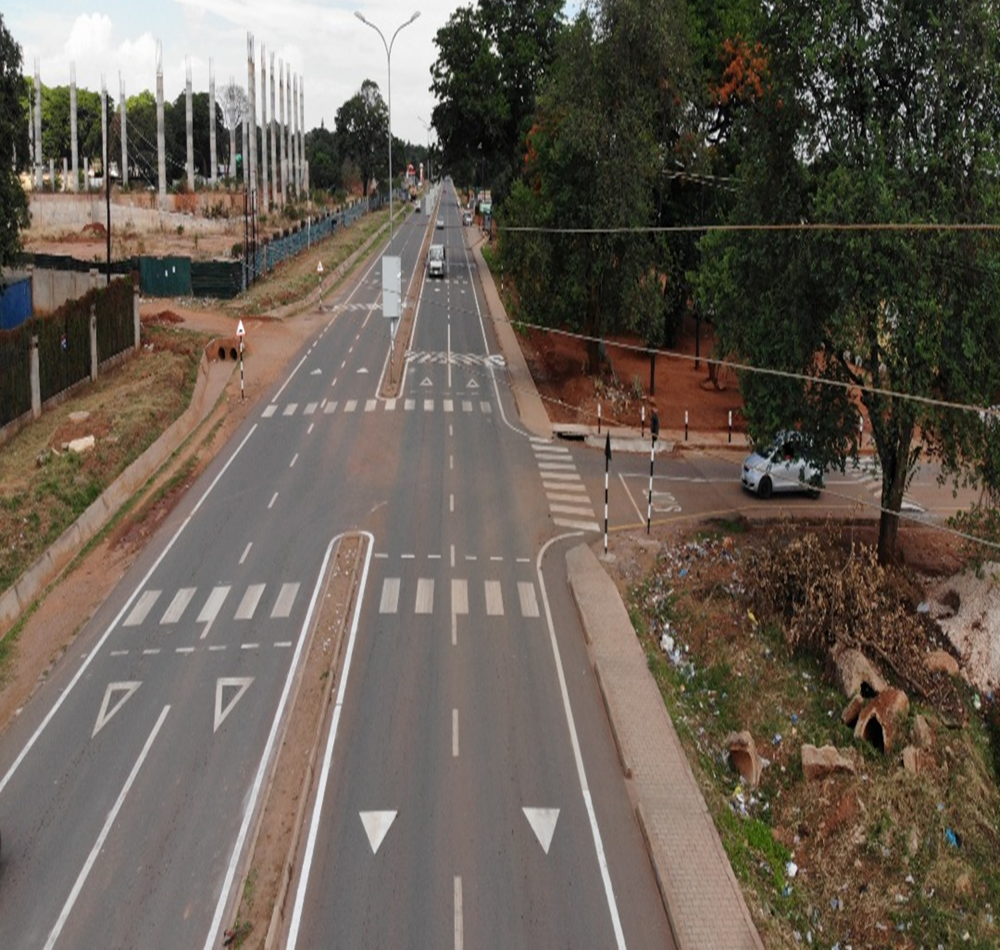 Major corridor using  marked zebra crossing, rumble strips, signs outside Chilenje B Primary School a ZRST-supported school