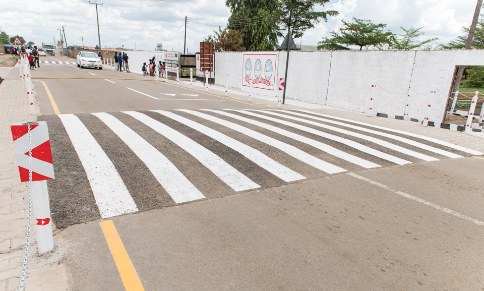Zambian schoolchildren and community members participating in a road safety activity supported by Zambia Road Safety Trust