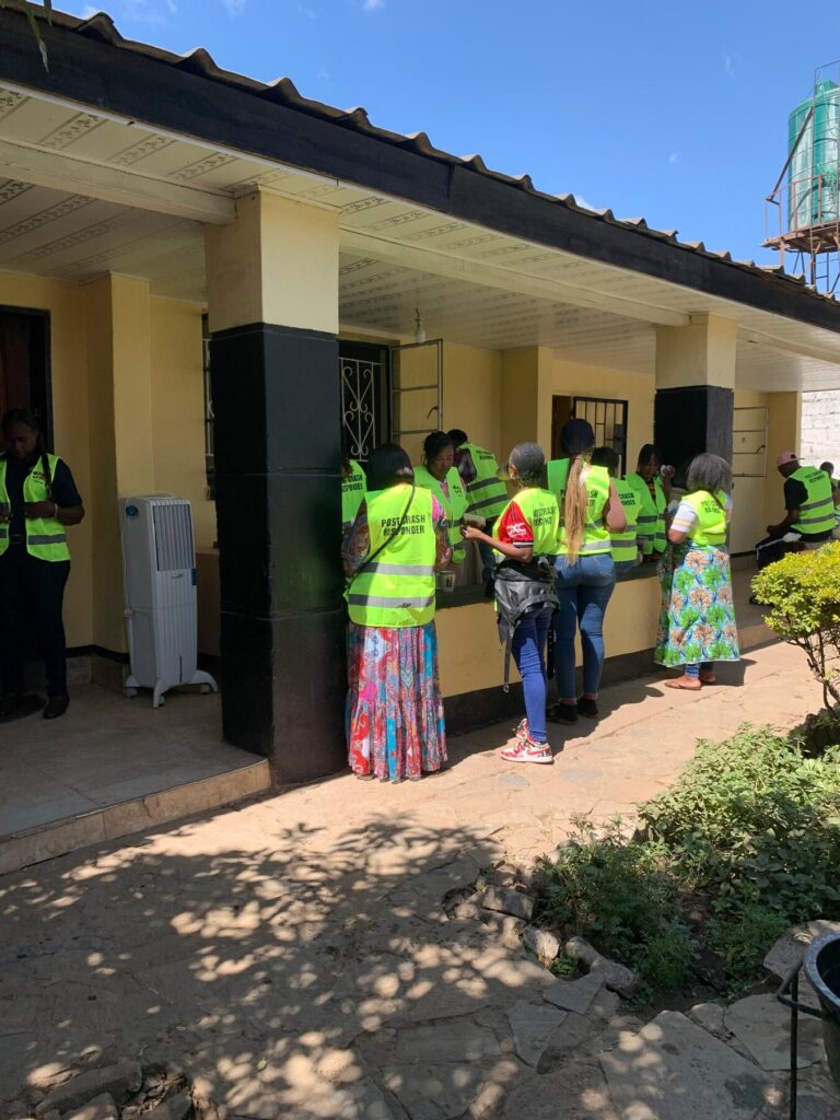 Training participants outside a building wearing Post Crash Responder vests.