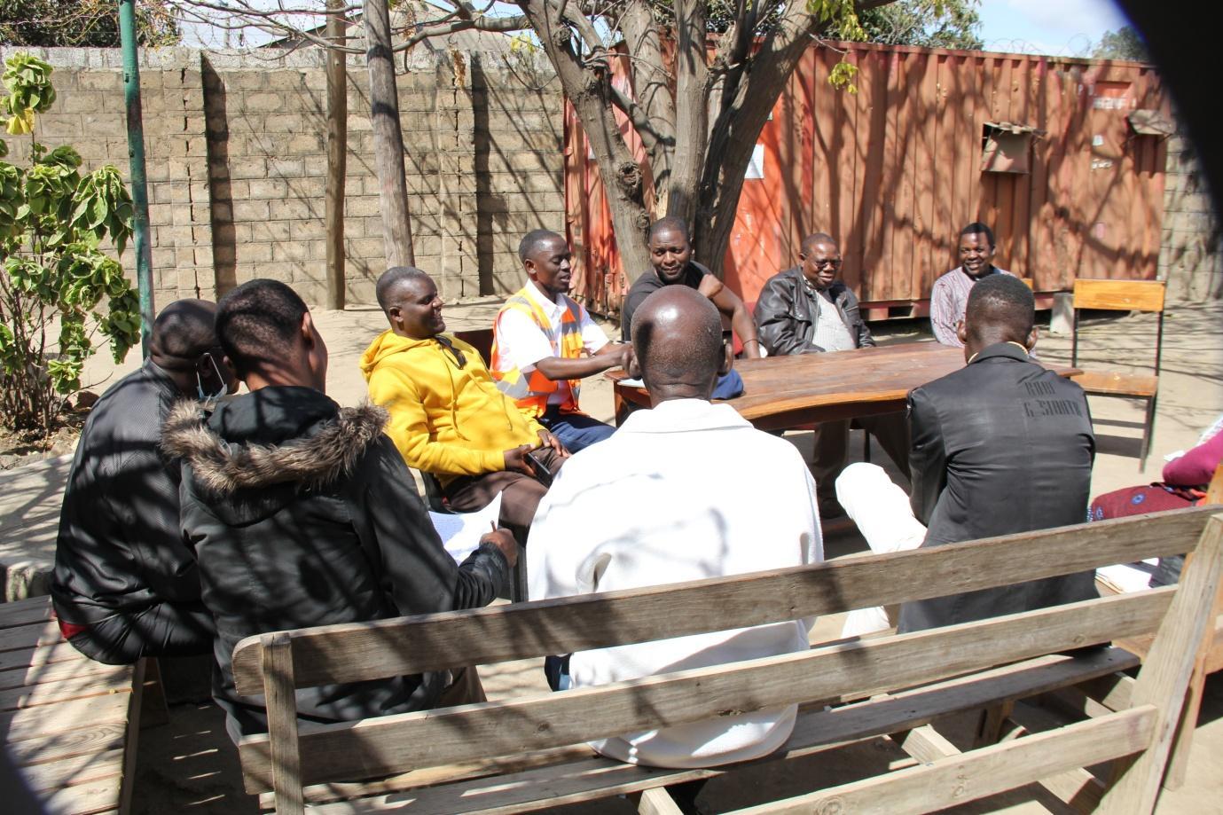 Residents and project participants meeting outdoors during the ZRST open-mapping project in Lusaka